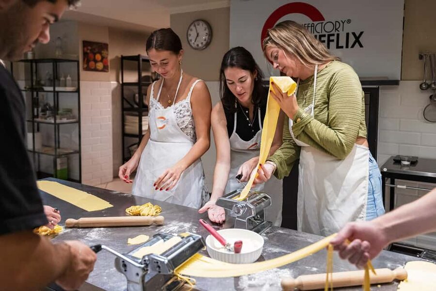 Florence: Handmade Pasta & Dessert Class with Unlimited Wine - Mixing dough by hand, then using the tools