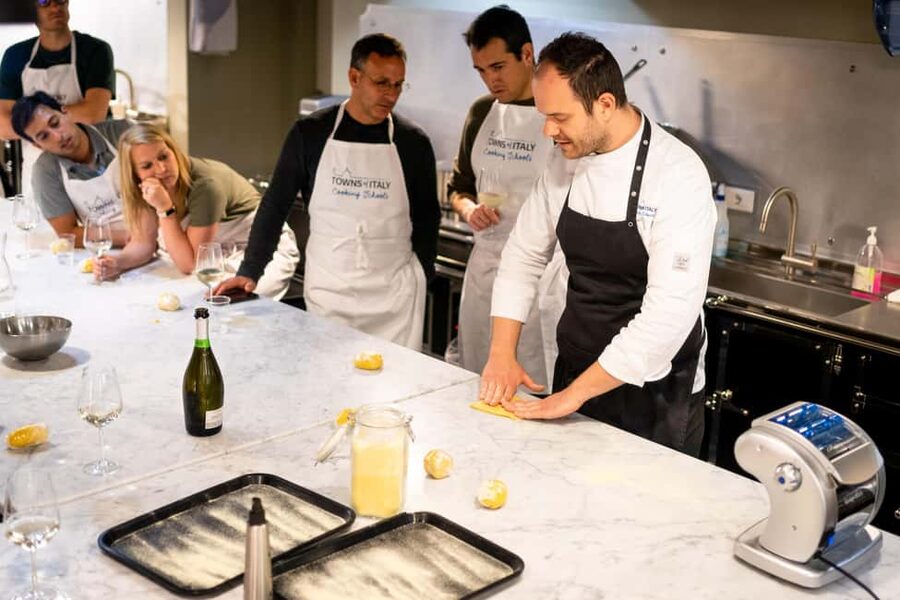 Milan: Pasta Class with Gelato or Tiramisù & Unlimited Wine - Sitting down to eat with Prosecco