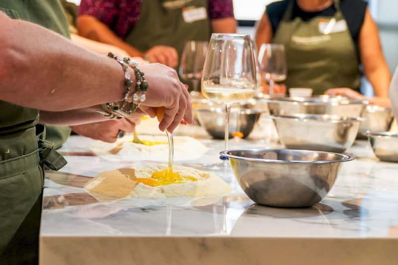 Rome: Hands-On Pasta & Tiramisu Class with Unlimited Wine - Mixing flour and eggs for fresh fettuccine